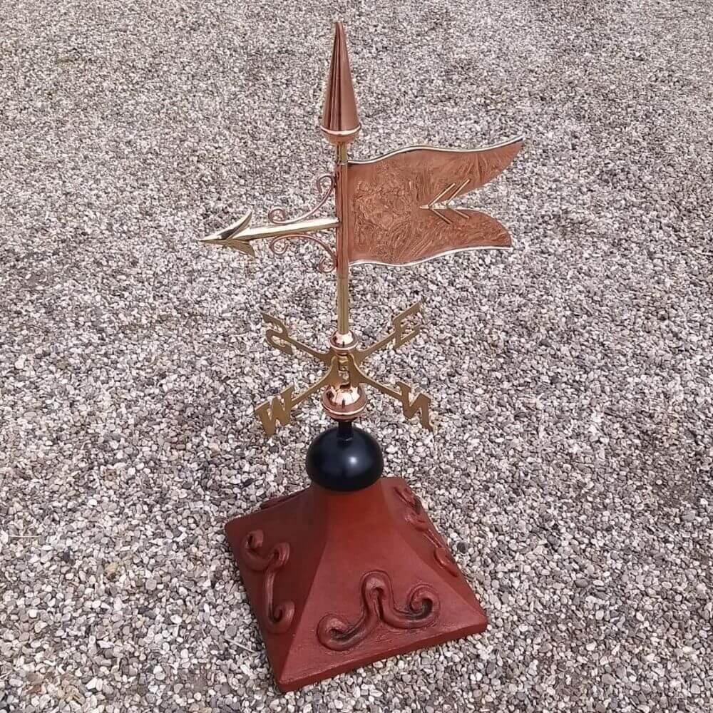 Banner weathervane mounted on a square roof tile capping