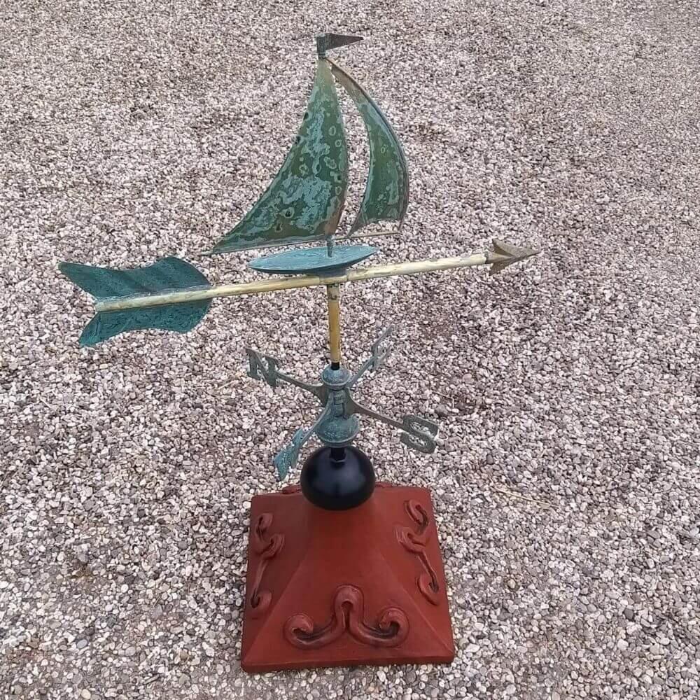 Sailboat weathervane fixed on a square ridge tile cap