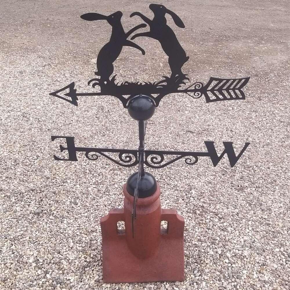 Boxing hares weathervane fitted to a 45 degree ridge finial
