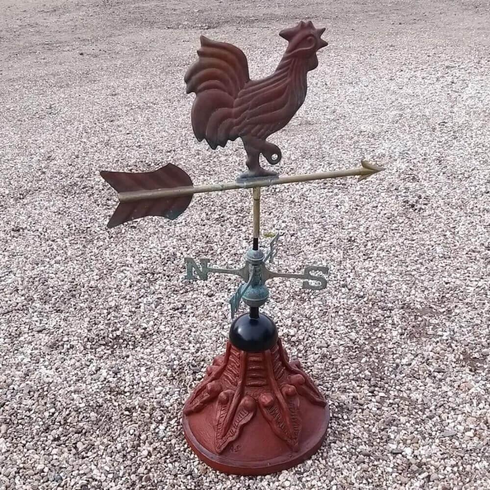 Cockerel weathervane fixed to a round ridge tile round cap