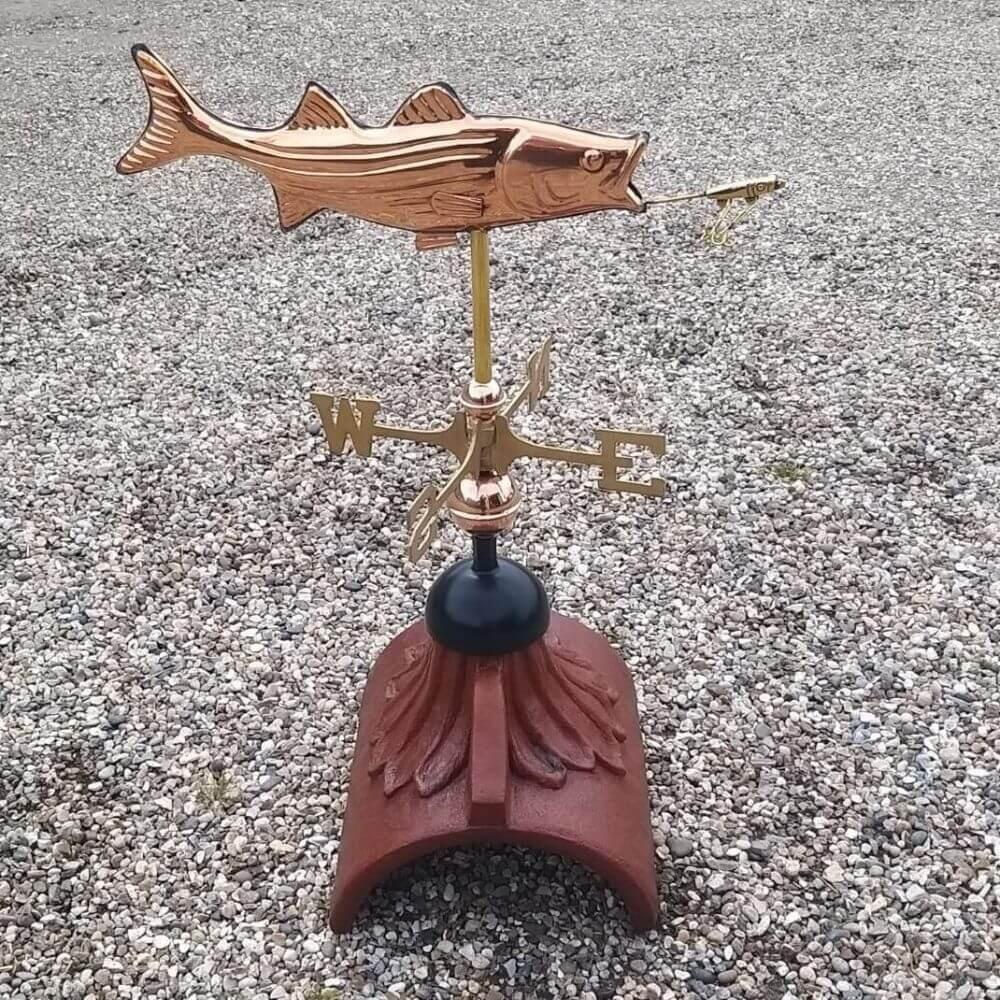 Fish weathervane mounted on a half round ridge tile