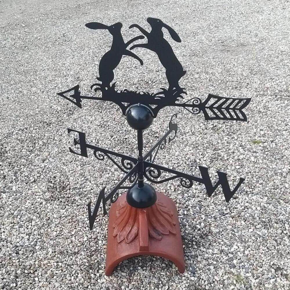Boxing hares weathervane fitted on a half round ridge