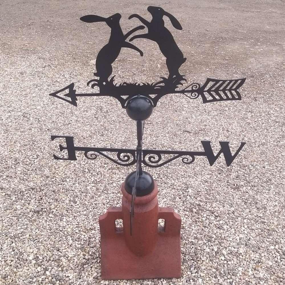 Boxing hares weathervane fitted to a 45 degree ridge finial