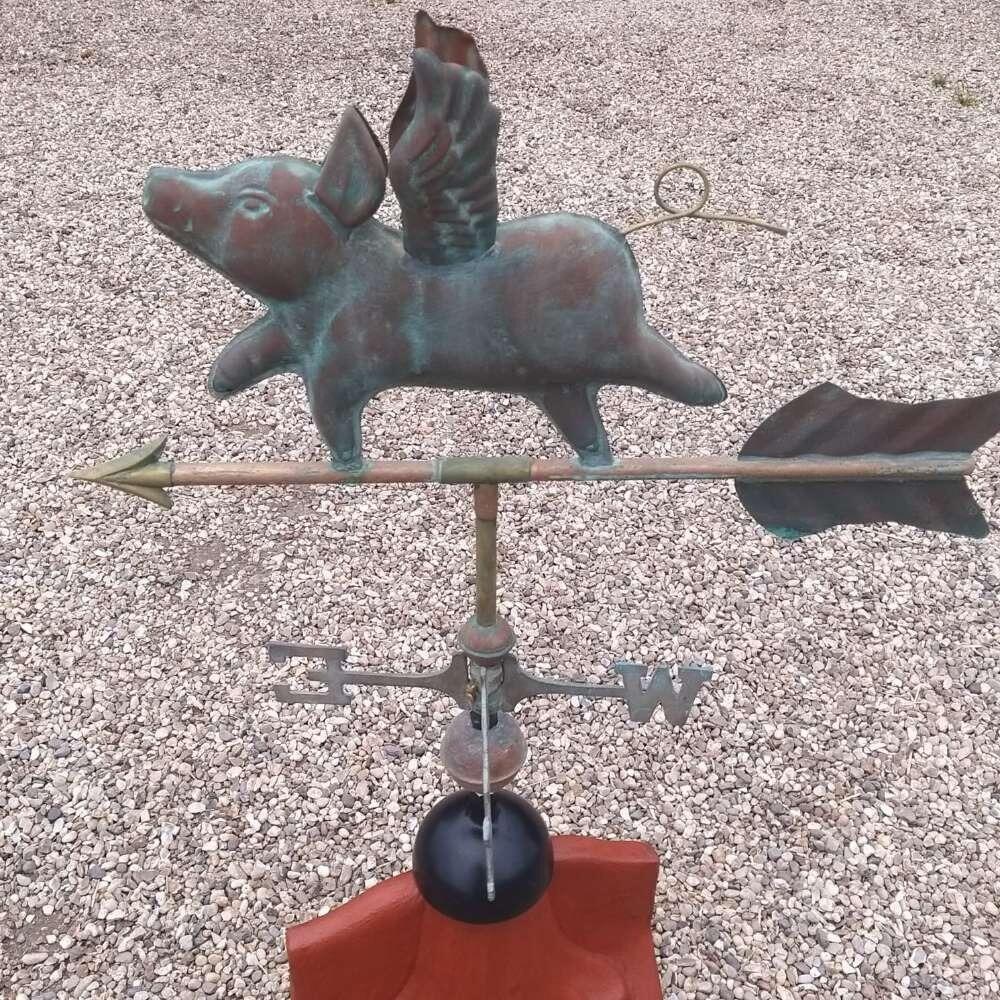 Flying pig verdigris weathervane on a ridge tile finial fitting with multiple angle options