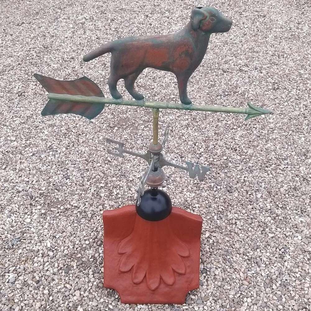 Dog verdigris weathervane fitted on a ridge tile finial fitting with multiple angle options