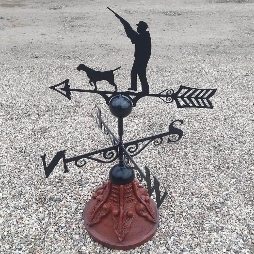Gun up hunting weathervane fitted on a round ridge tile capping
