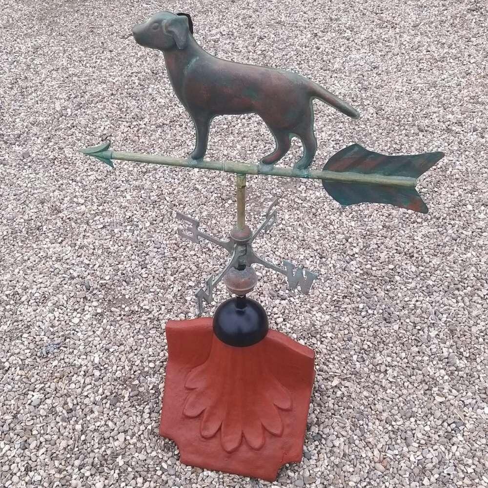 Dog verdigris weathervane fitted on a ridge tile finial fitting with multiple angle options
