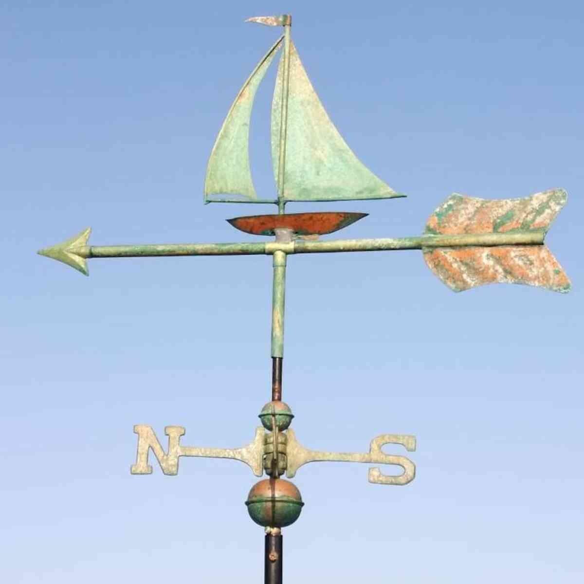 Copper verdigris sailboat weathervane showing directional arrow and cardinal point assembly