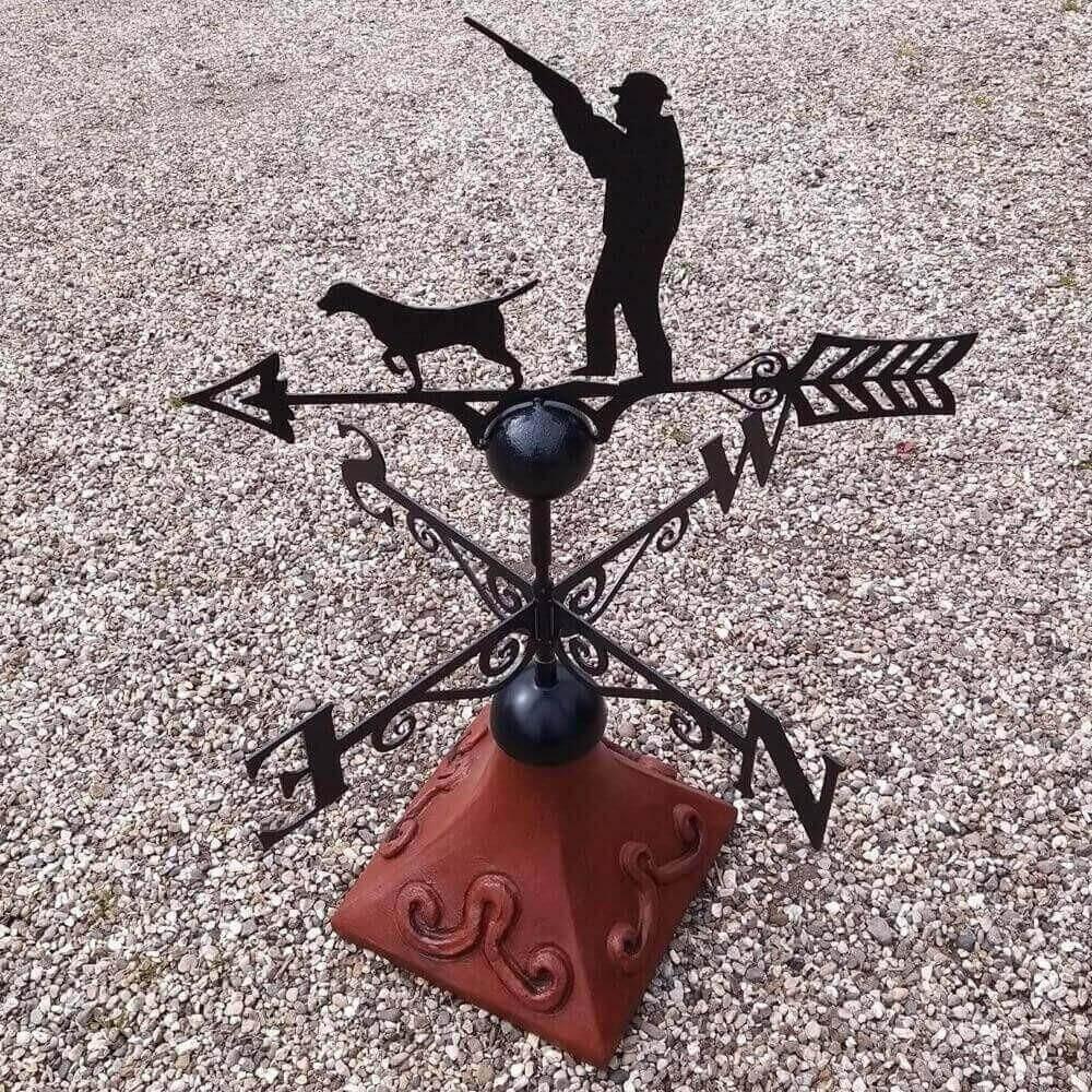 Gun up hunting weathervane fixed on a square ridge tile cap