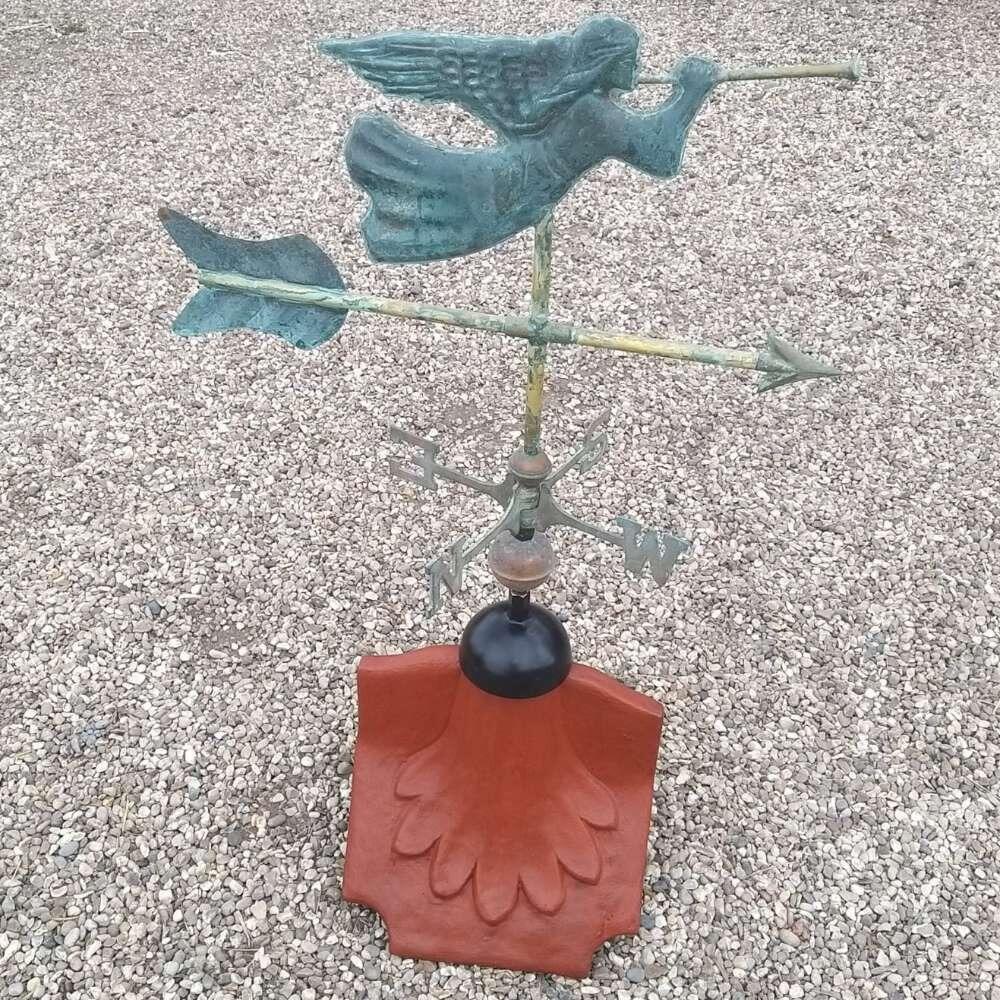 Angel verdigris weathervane installed on a ridge tile finial fitting with multiple angle options