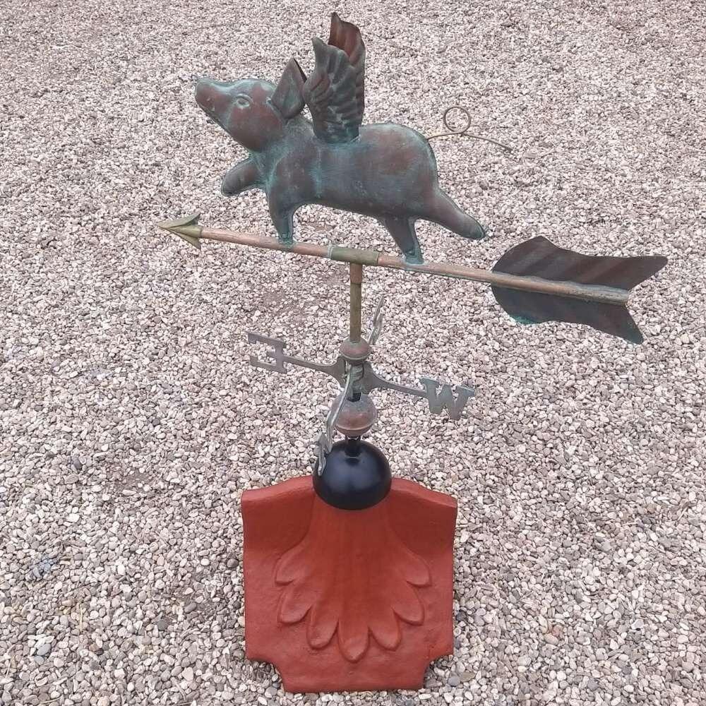 Flying pig verdigris weathervane on a ridge tile finial fitting with multiple angle options