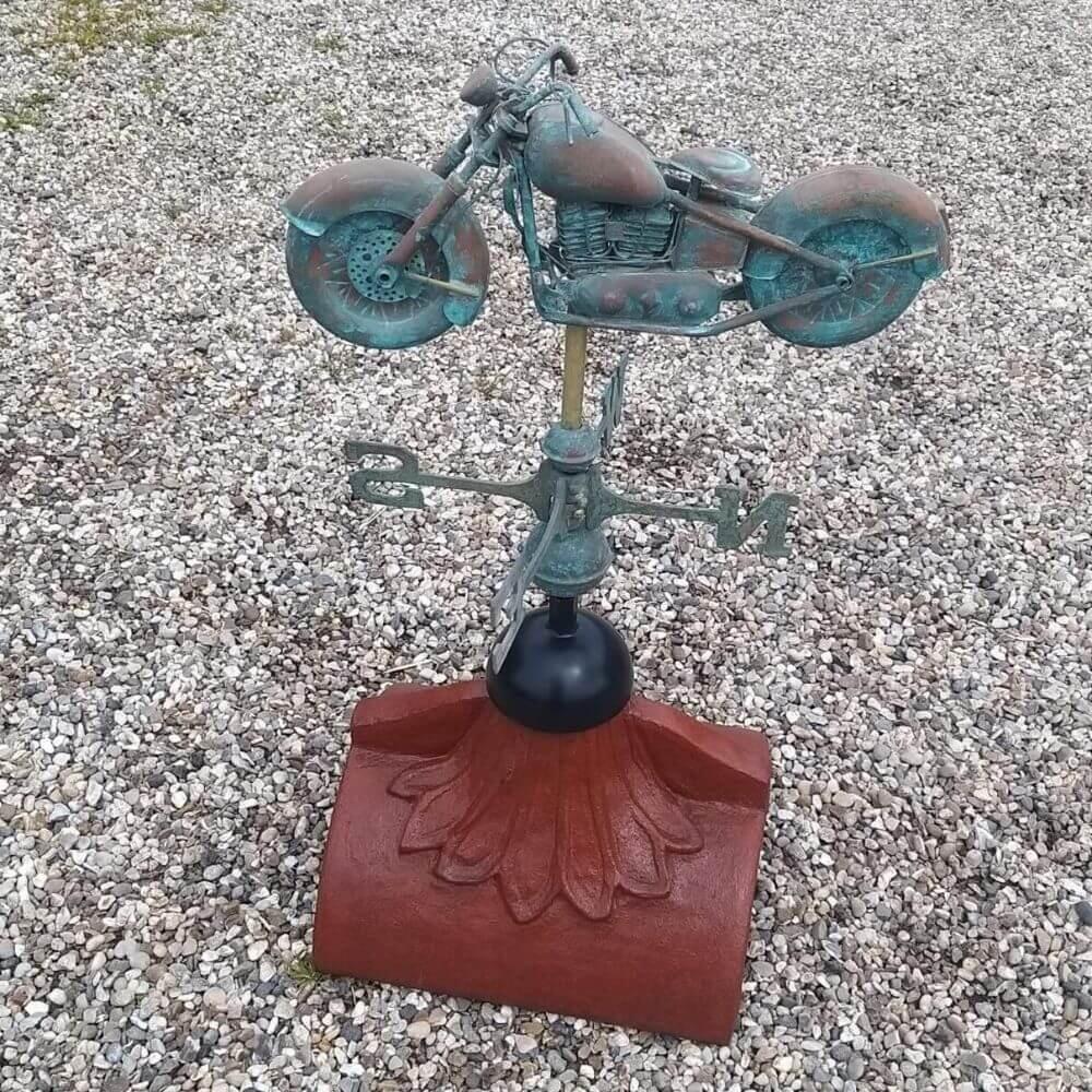 Motorbike weathervane mounted on a half round roof ridge finial