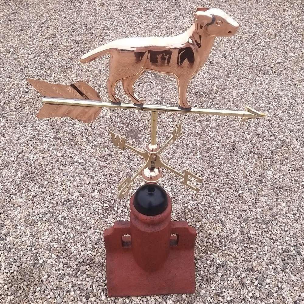 Dog weathervane mounted on a 45 degree ridge base finial