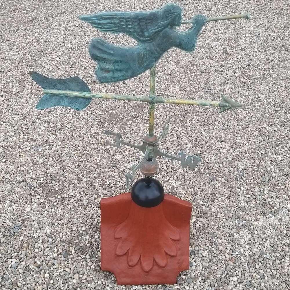 Angel verdigris weathervane installed on a ridge tile finial fitting with multiple angle options