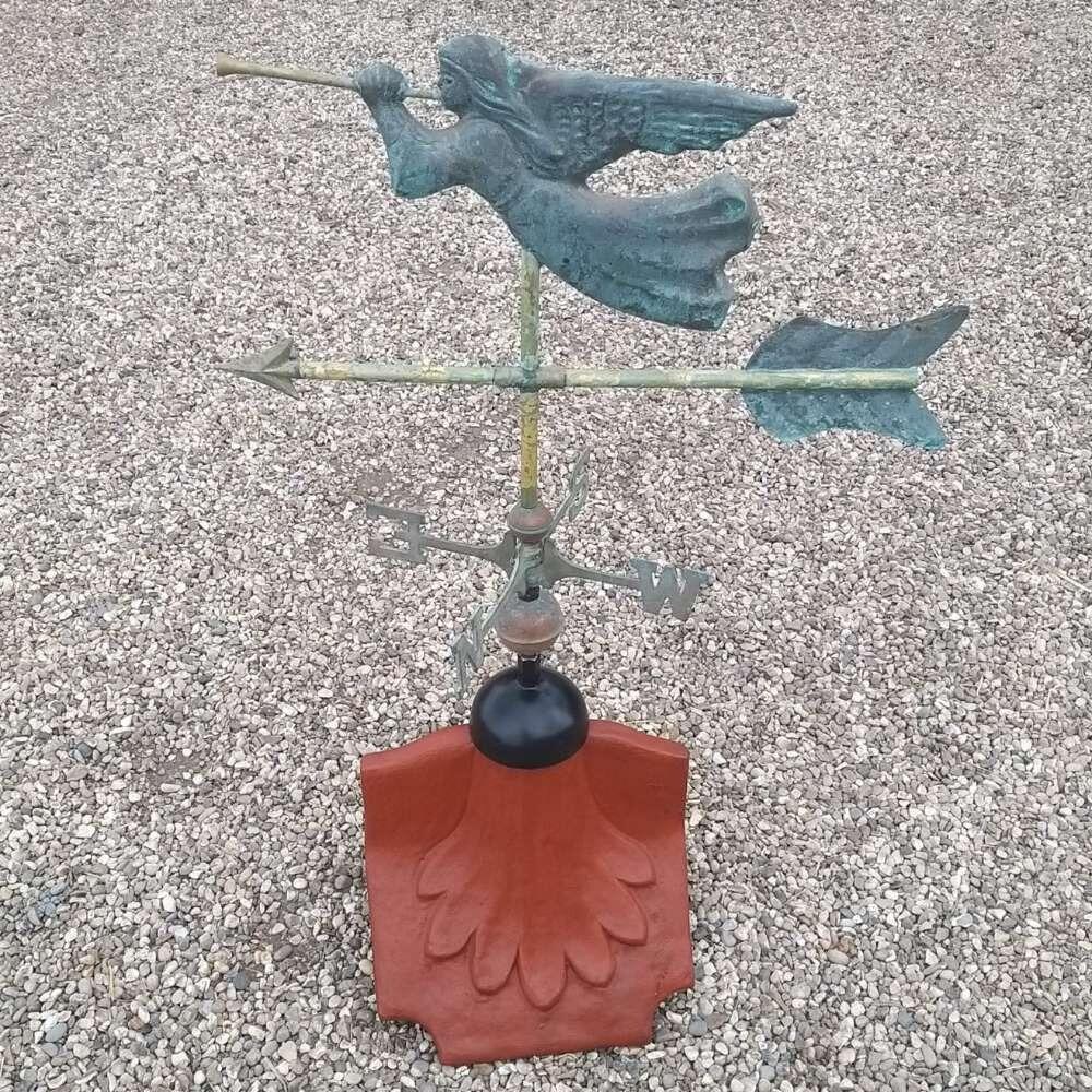 Angel verdigris weathervane installed on a ridge tile finial fitting with multiple angle options
