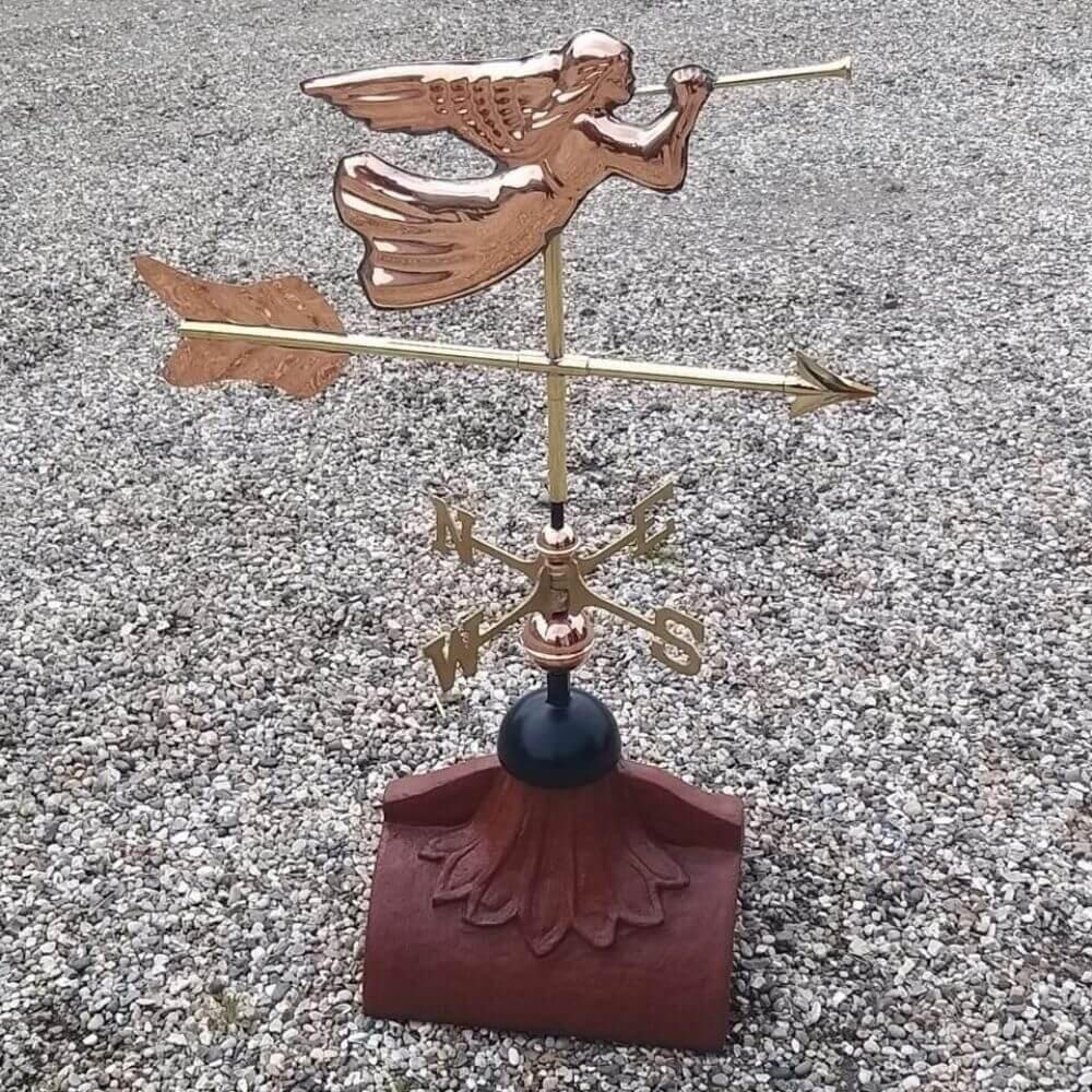 Angel weathervane installed on a half round ridge finial
