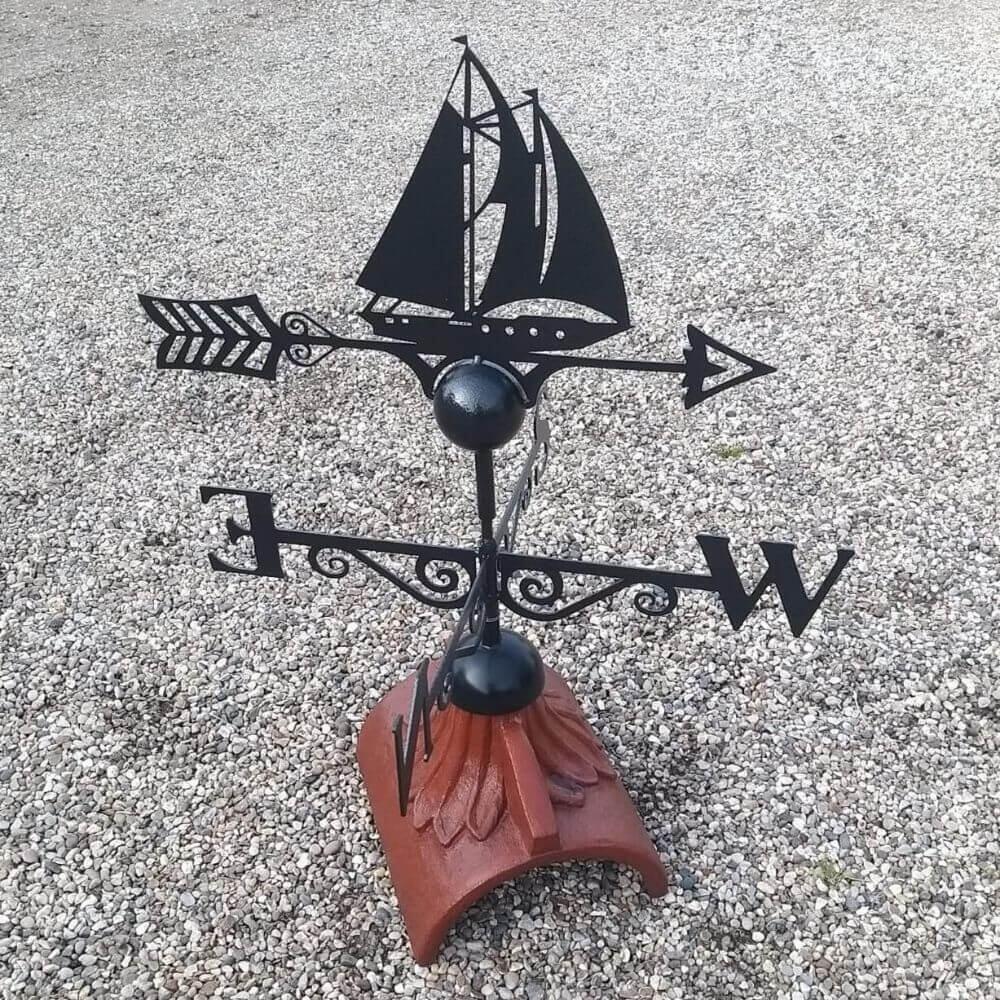 Sailboat weathervane installed on a half round roof ridge
