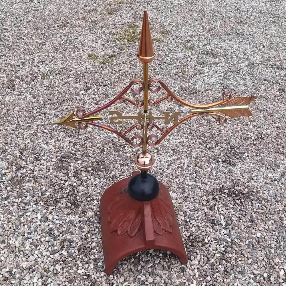 Copper Victorian arrow weathervane fitted on a half round ridge
