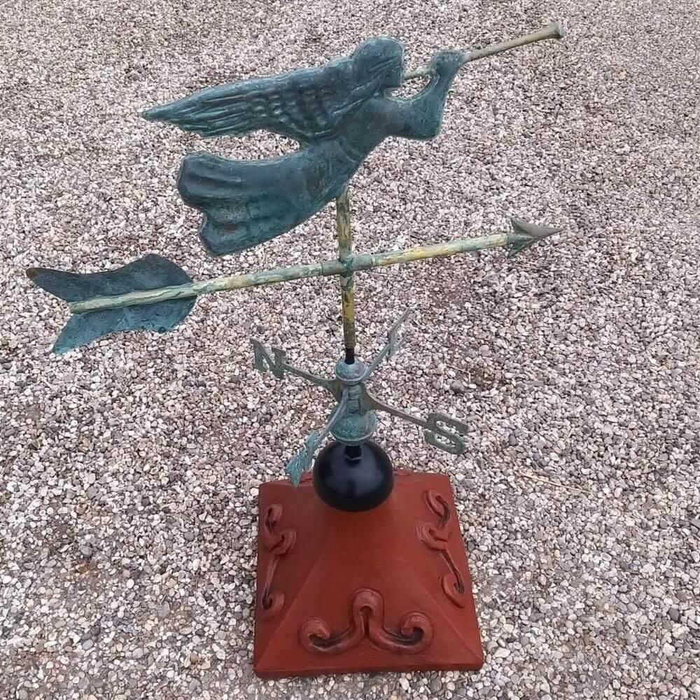 Angel weathervane fitted to a square ridge tile cap