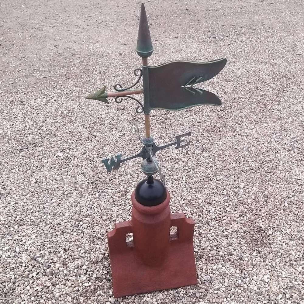 Verdigris banner weathervane fixed on a 45 degree ridge base finial