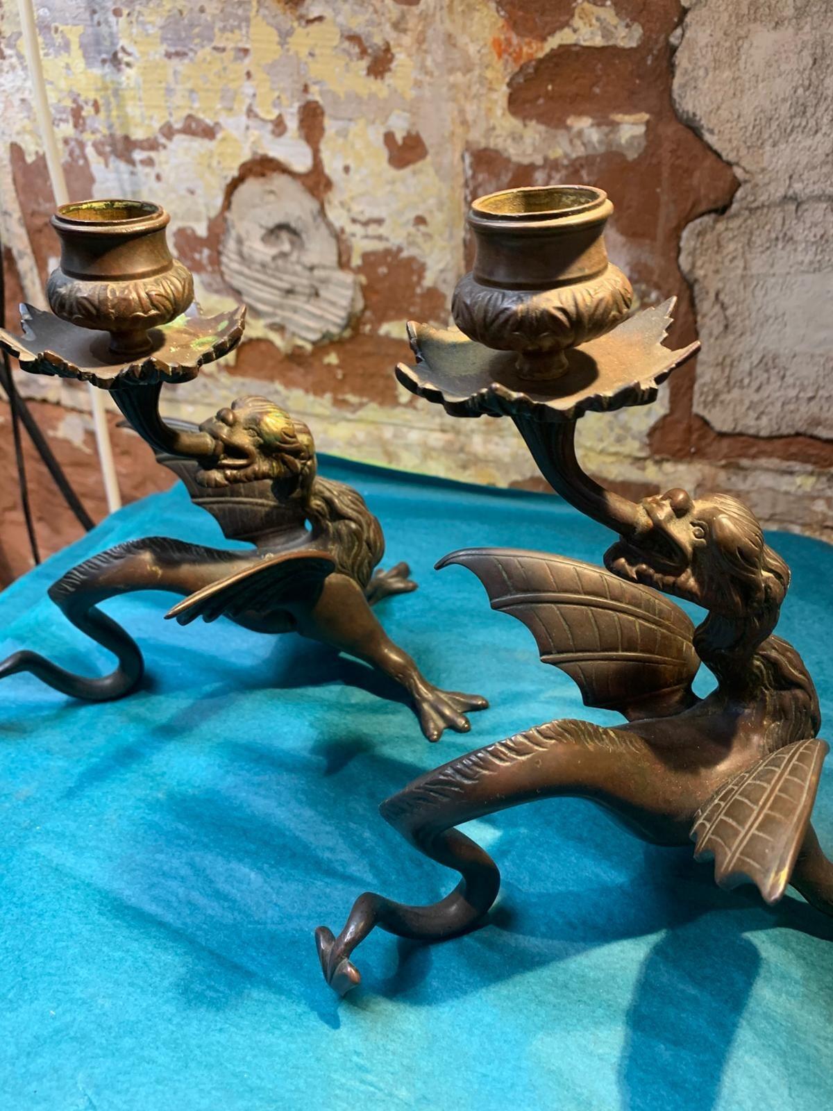 Antique pair of bronze mythical beast candlesticks