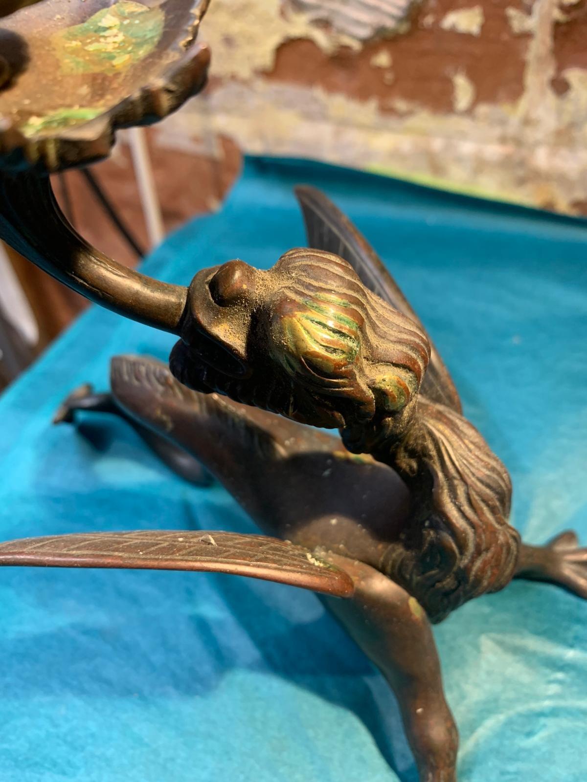 Antique pair of bronze mythical beast candlesticks