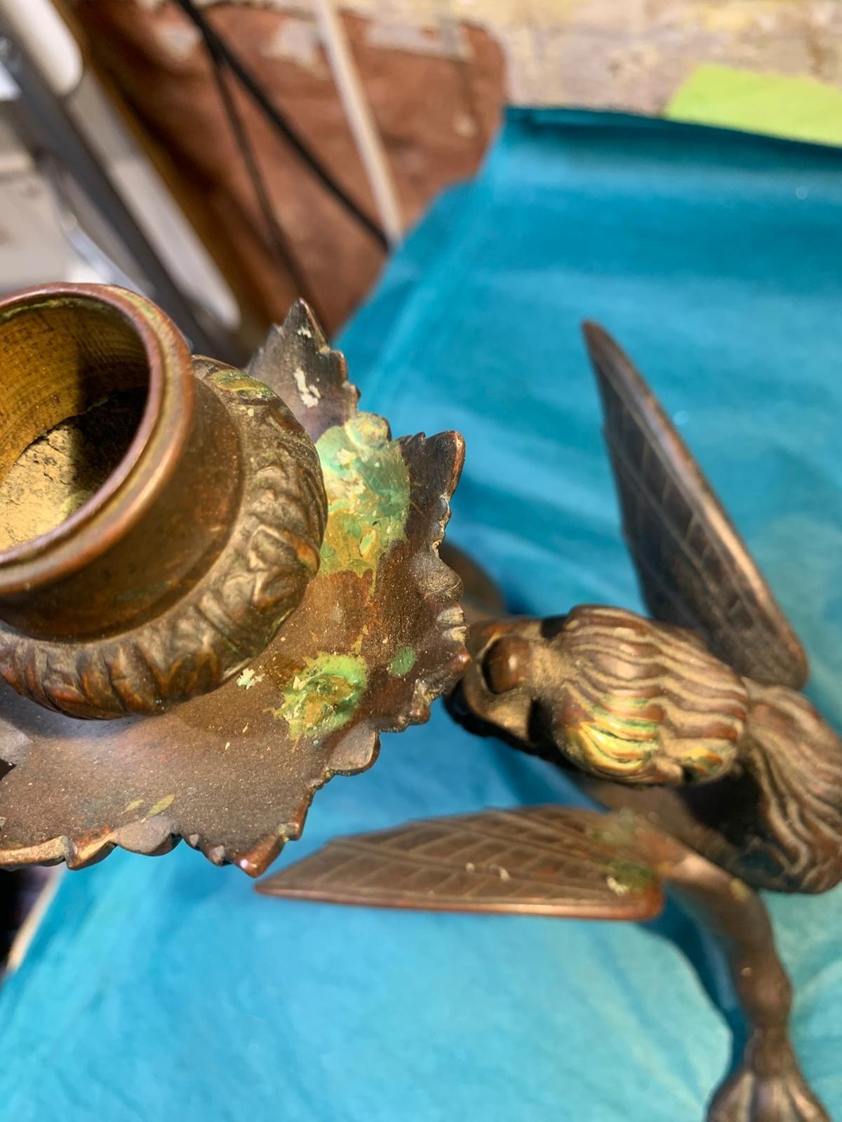 Antique pair of bronze mythical beast candlesticks