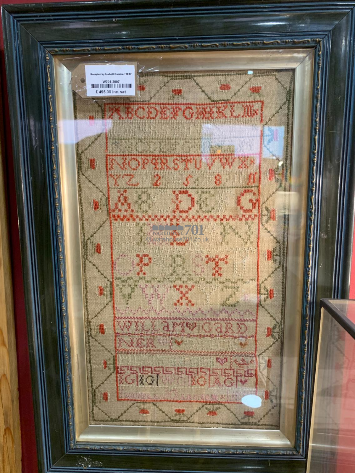 Alphabet sampler framed and glazed with a starwberry border - 1817