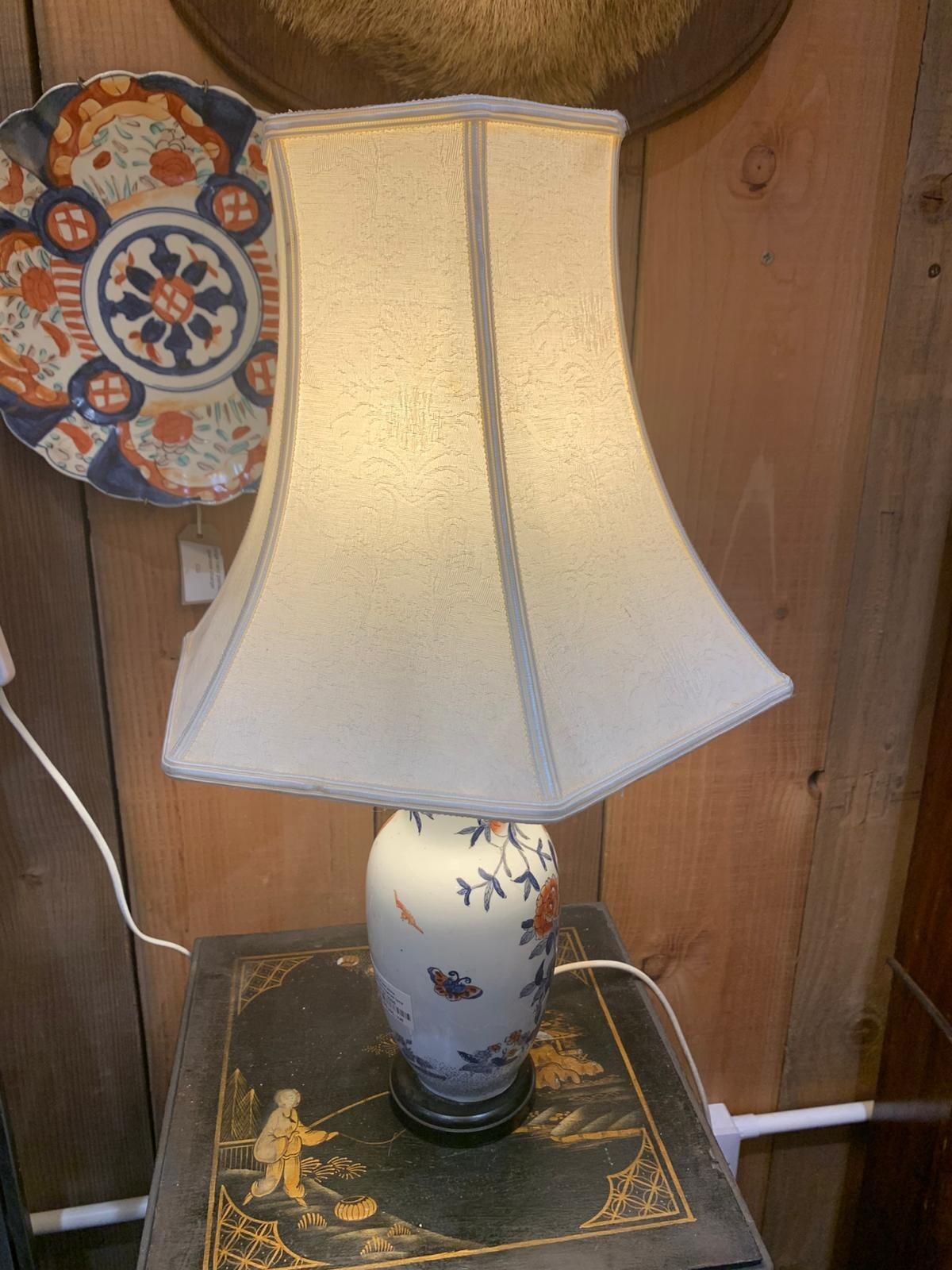 Blue and white lamp with crane