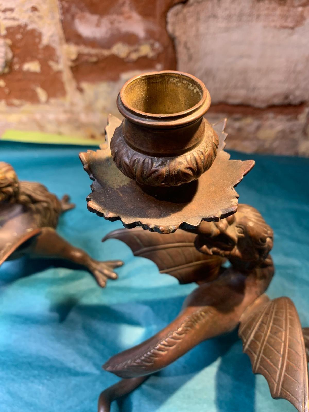 Antique pair of bronze mythical beast candlesticks
