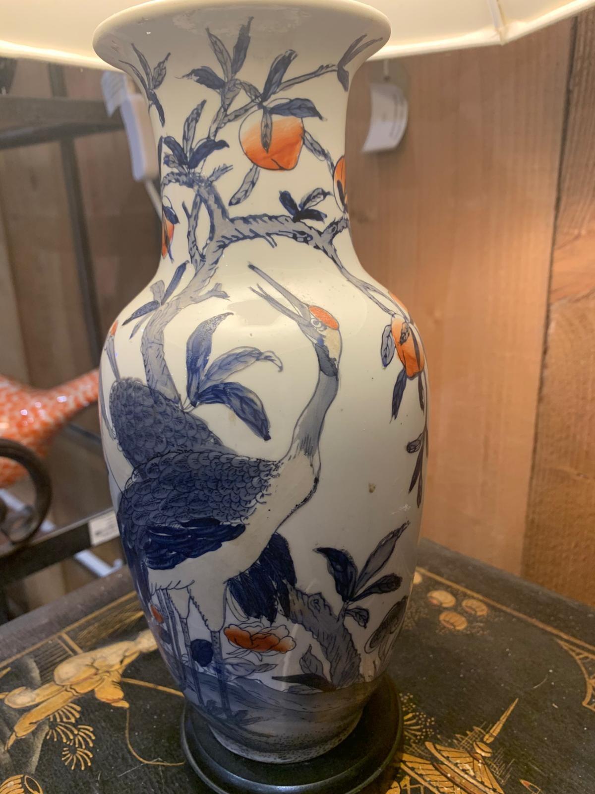 Blue and white lamp with crane