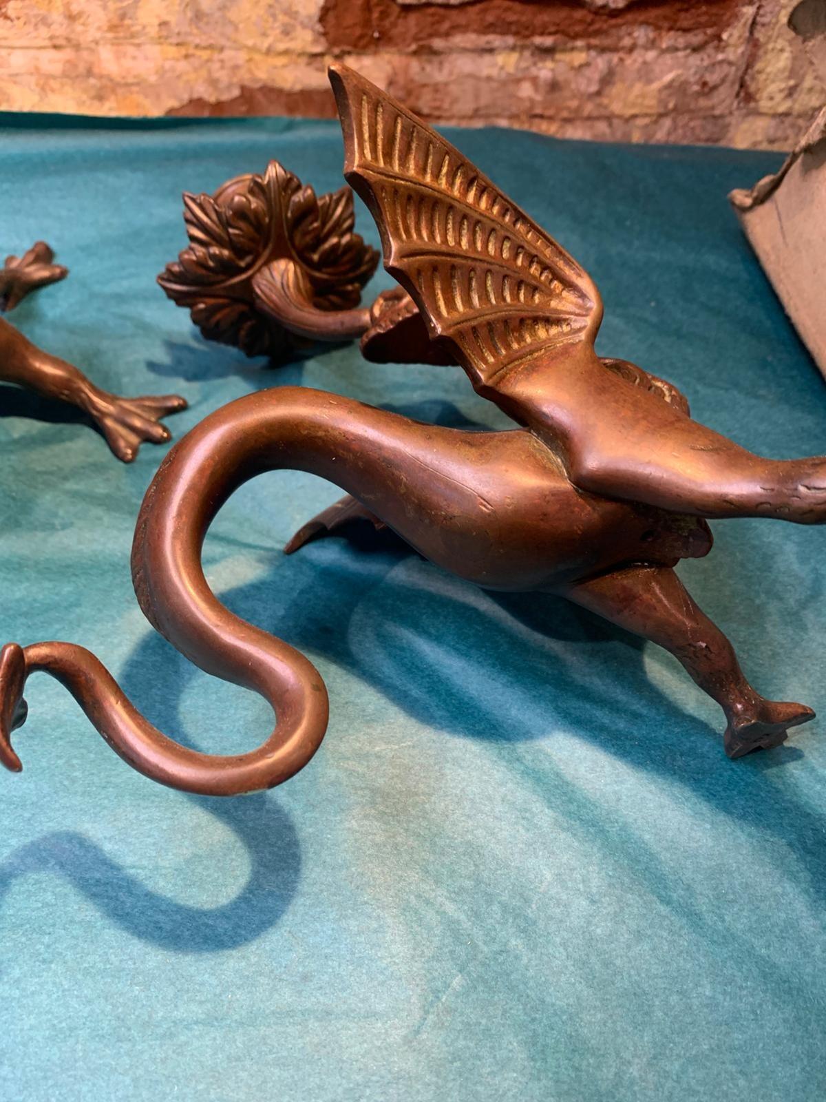 Antique pair of bronze mythical beast candlesticks