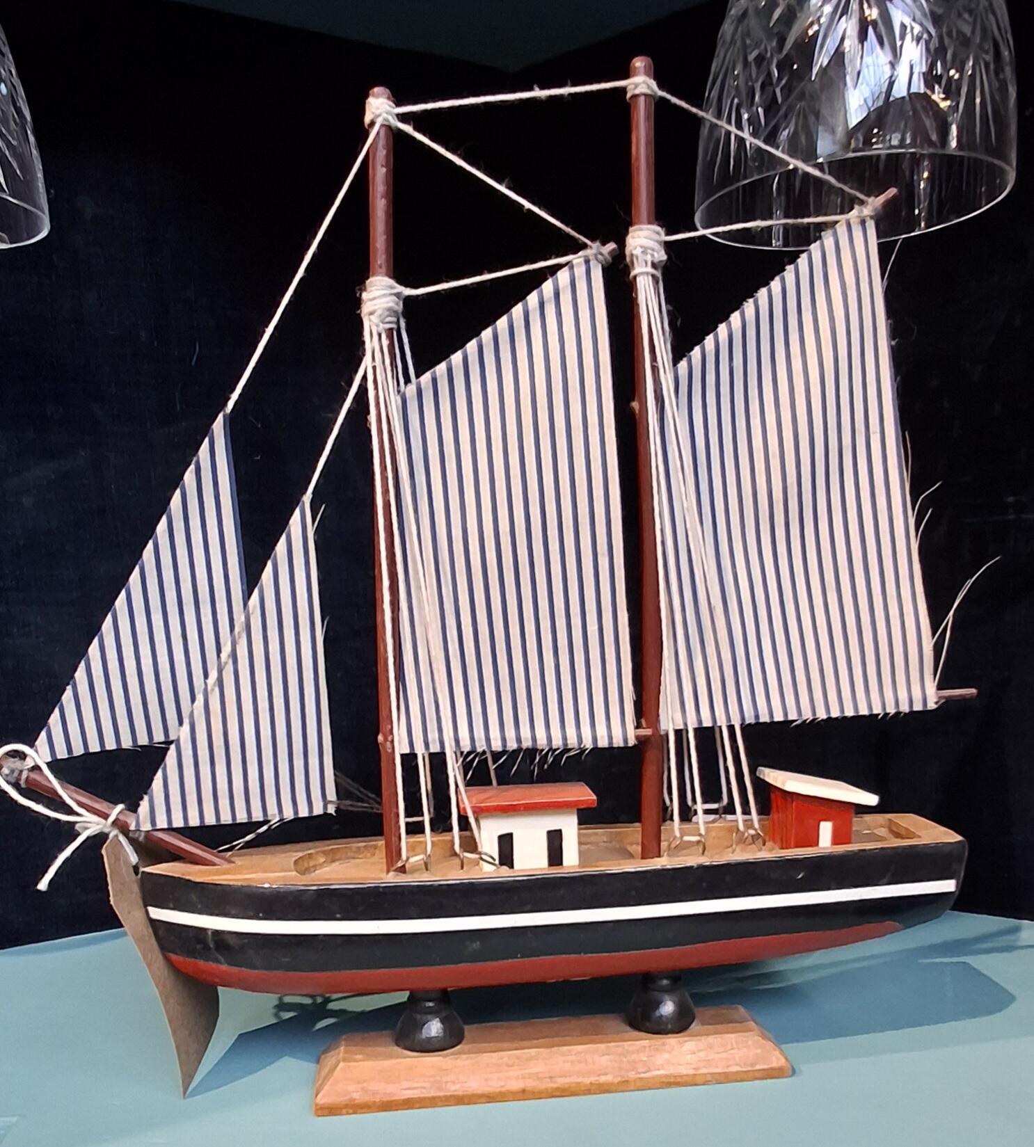 Small Model Ship with Blue Striped Sails
