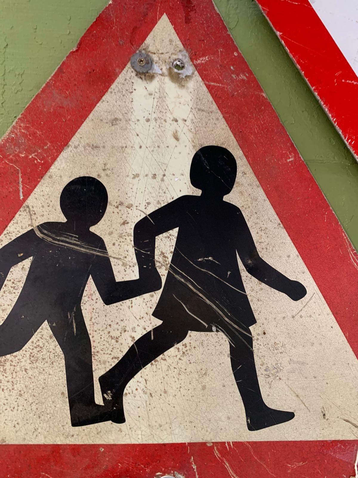Metal children crossing triangle sign
