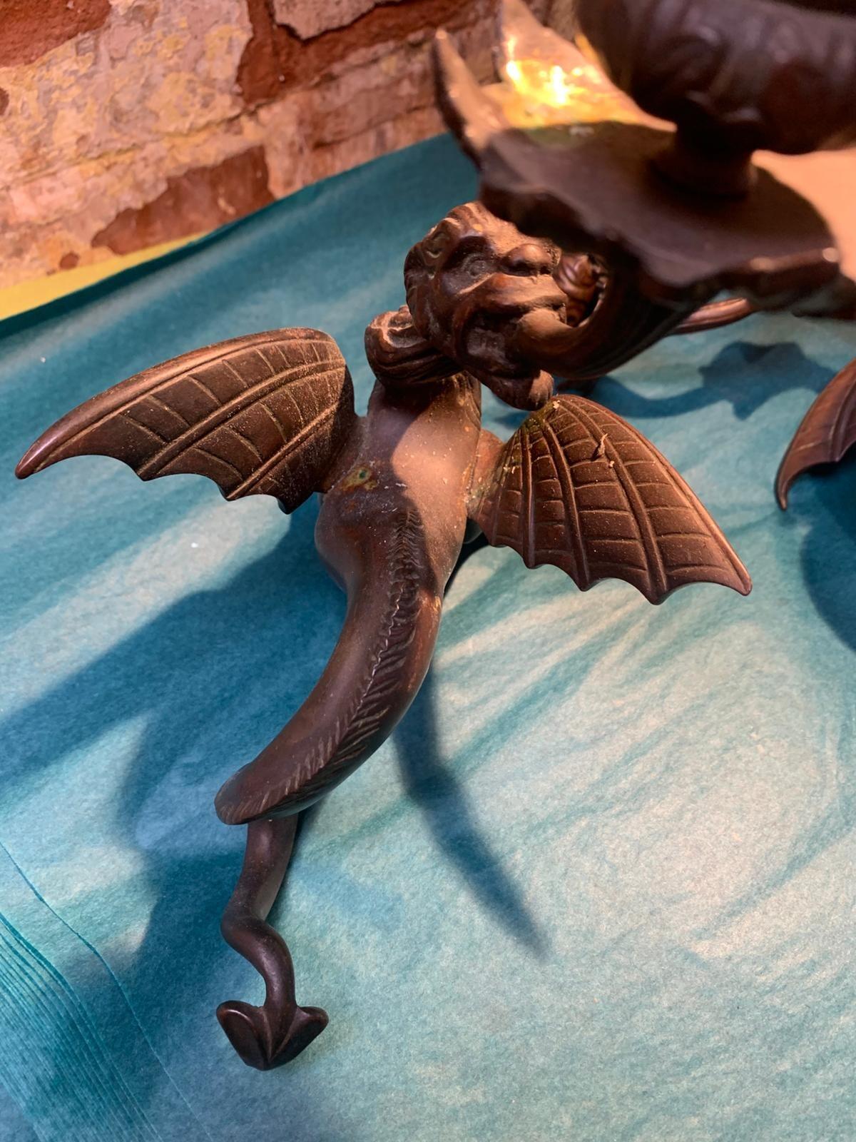 Antique pair of bronze mythical beast candlesticks