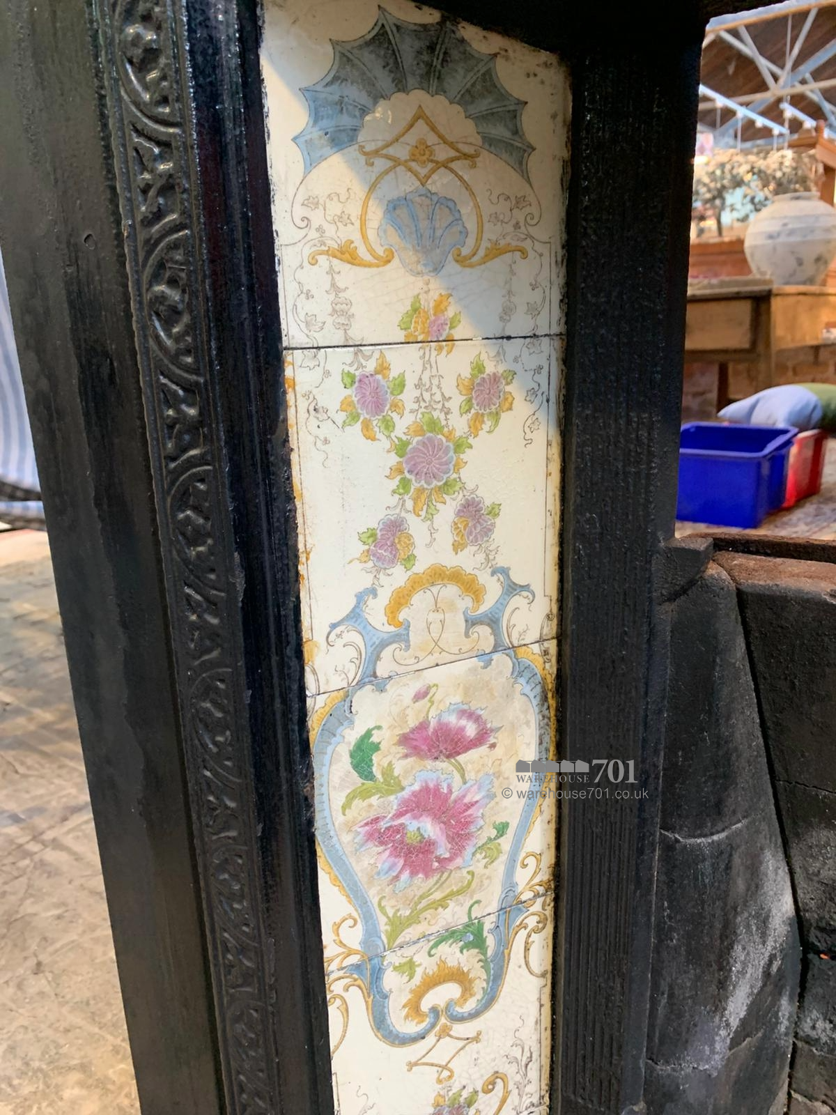 Cast iron fire place with floral tiles