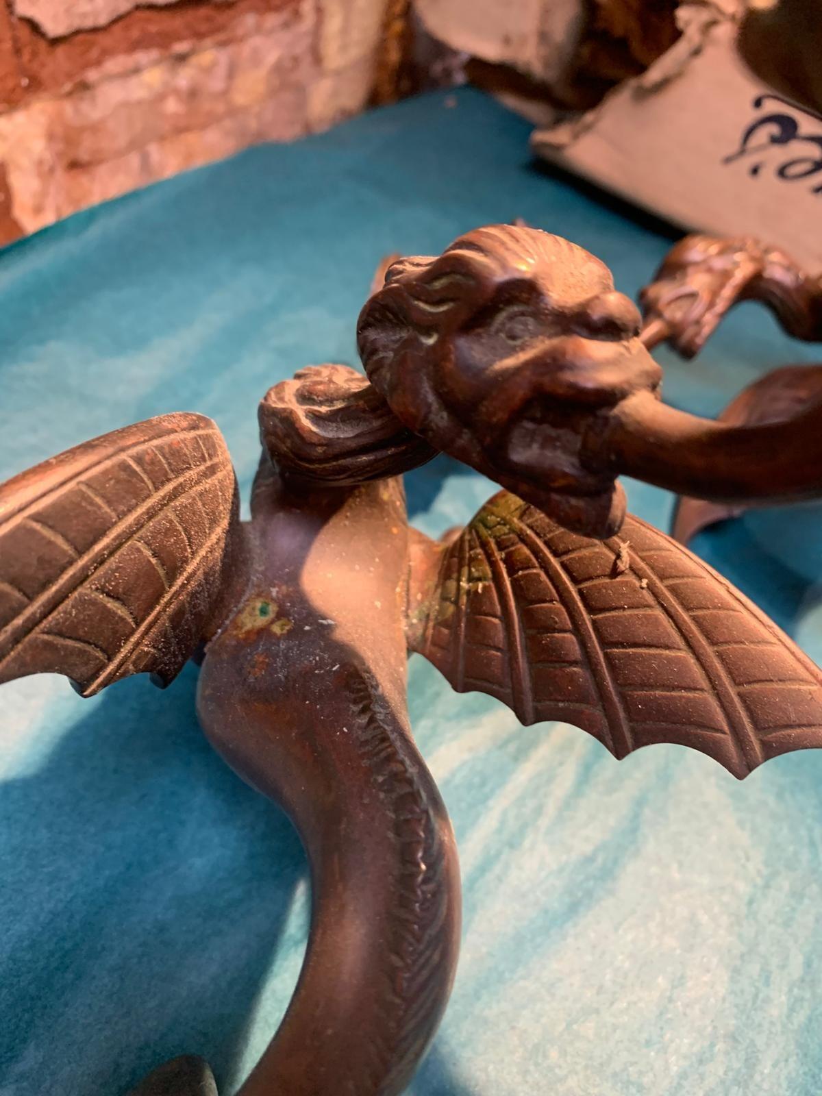 Antique pair of bronze mythical beast candlesticks