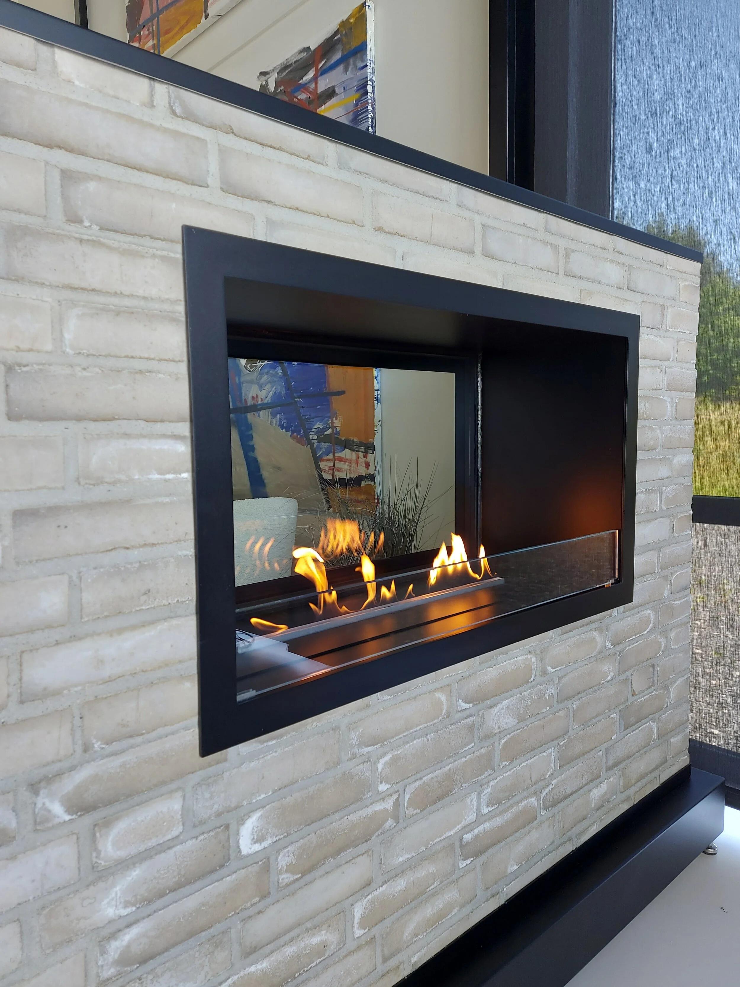 Montreal Clear fire in a pale brick wall with flames and a view through the glass