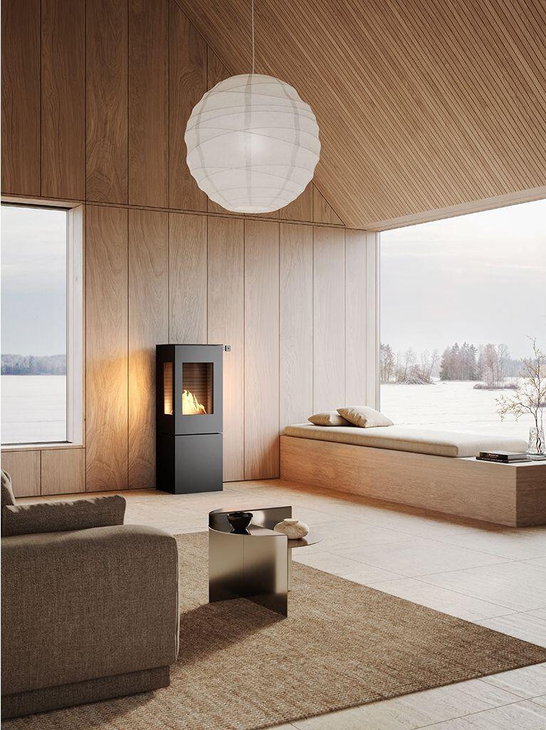 Rais Nexo 120 Bio in black against timber wall panelling with a winter view