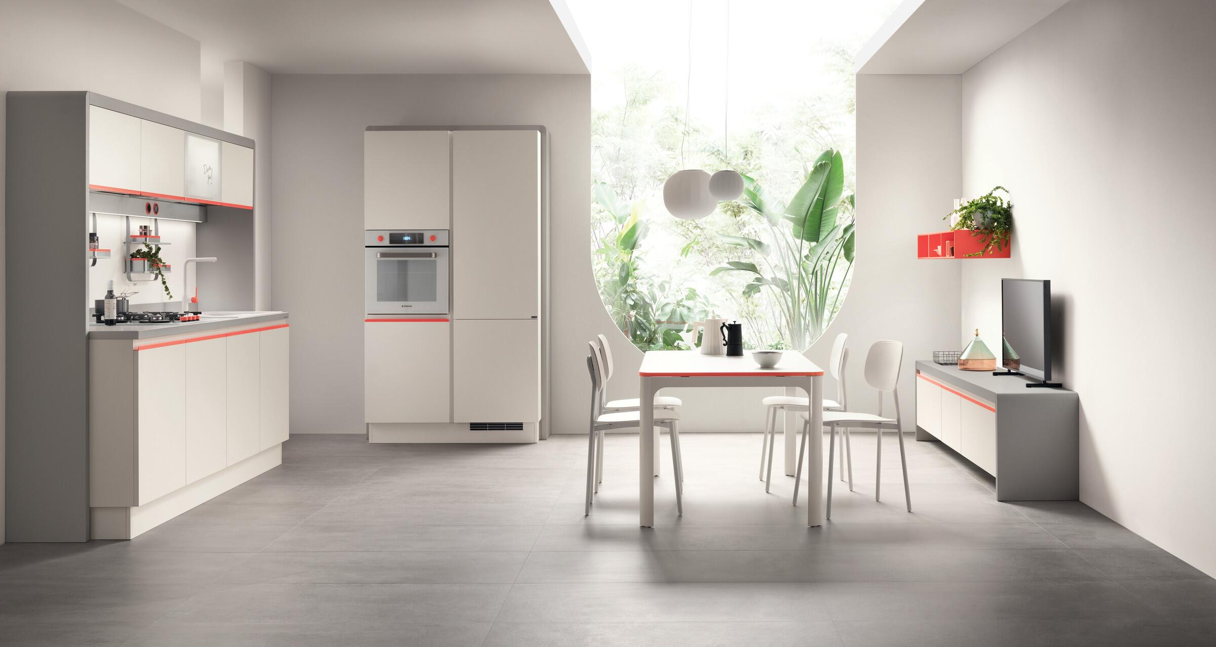 Scavolini Dandy Plus compact kitchen in white with red accents and a small dining table