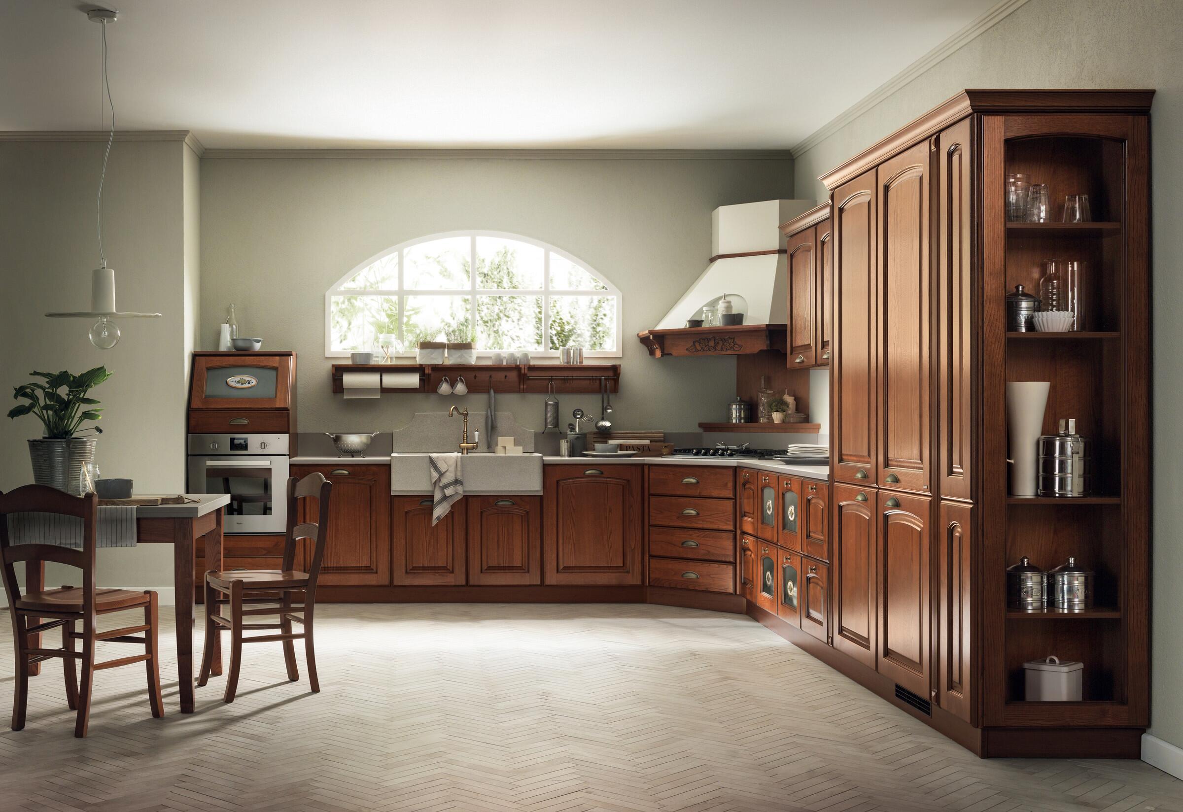 Scavolini Madeleine kitchen in rich chestnut wood with a tall glazed display unit