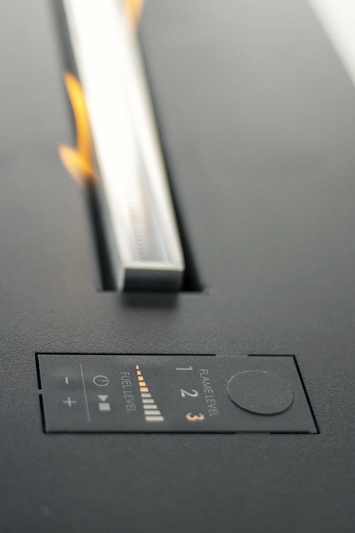 Close-up of the Denver F3 burner control panel on the black top plate