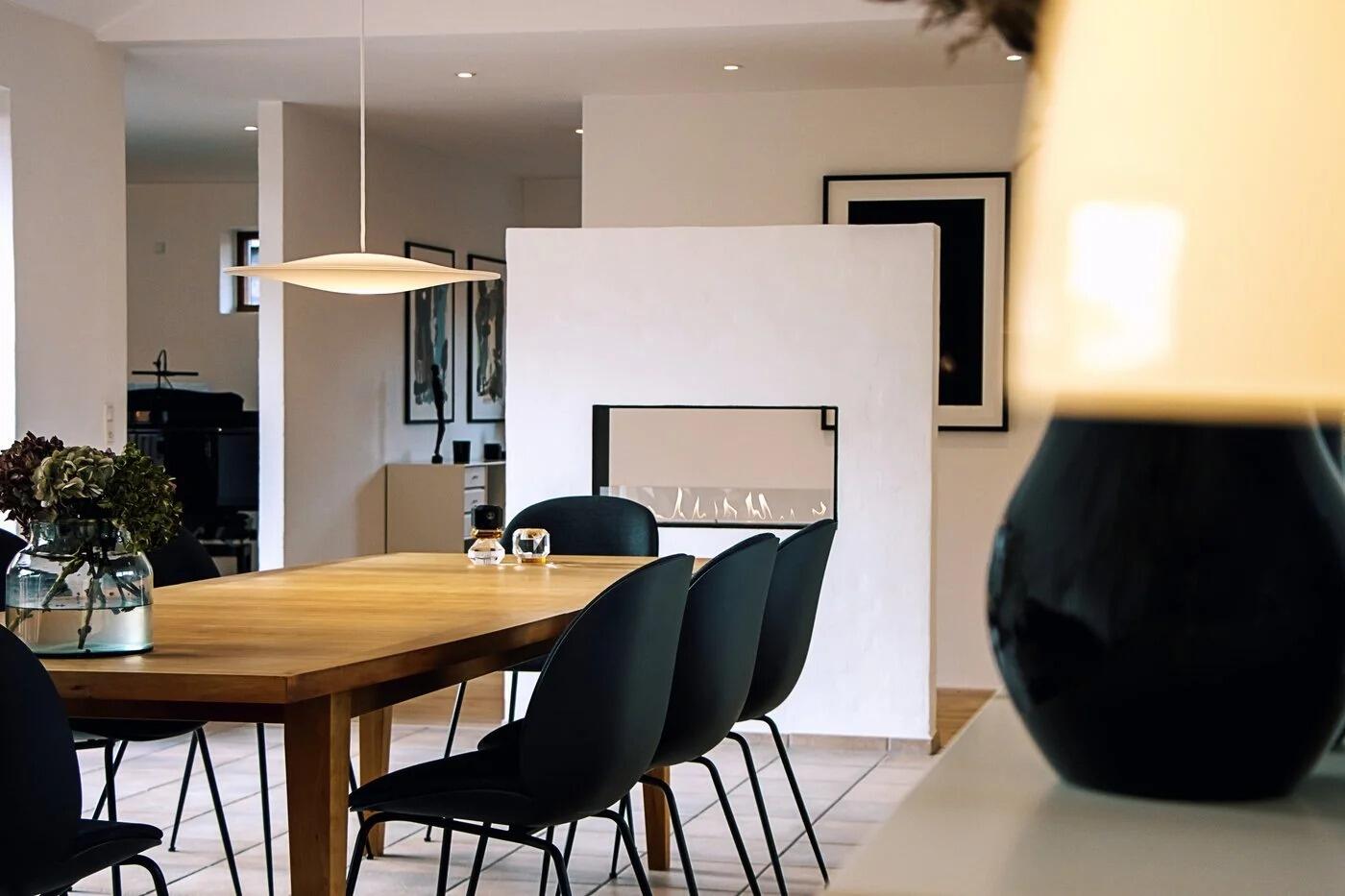 Montreal see-through fire in a white wall between dining and living areas