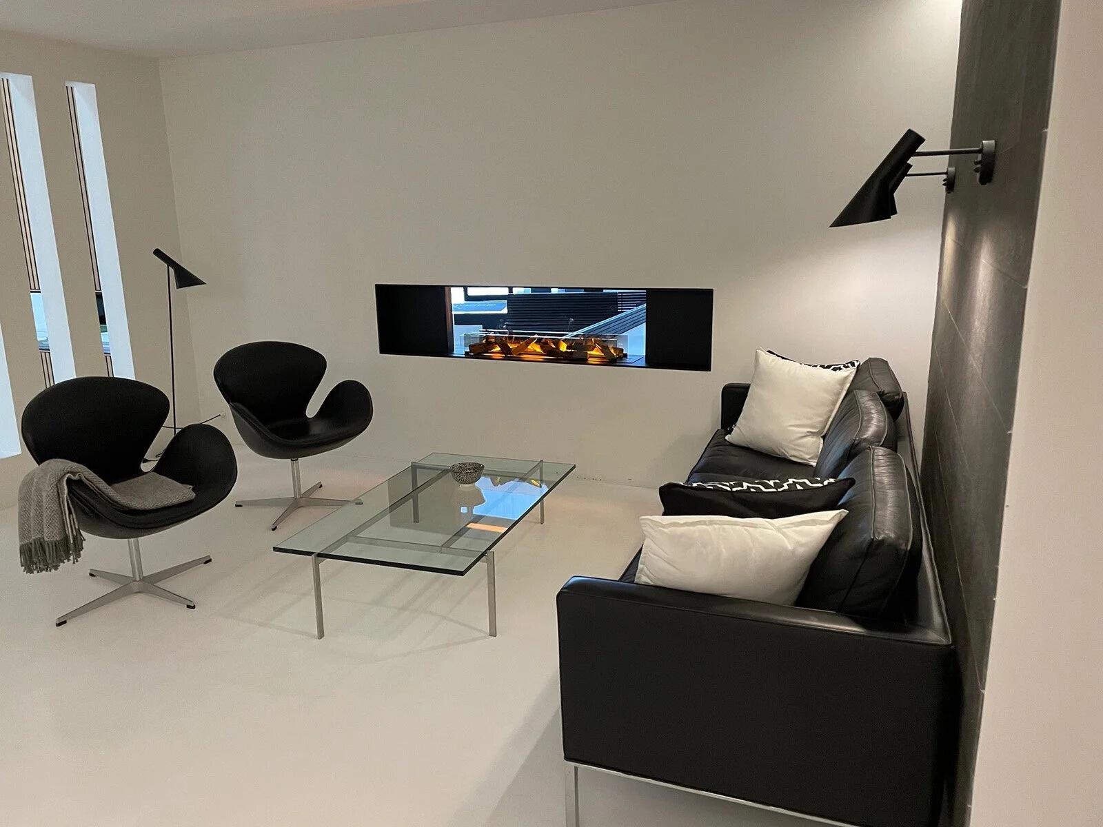 Montreal Panorama Hybrid Mist fire above a black leather sofa in a white room