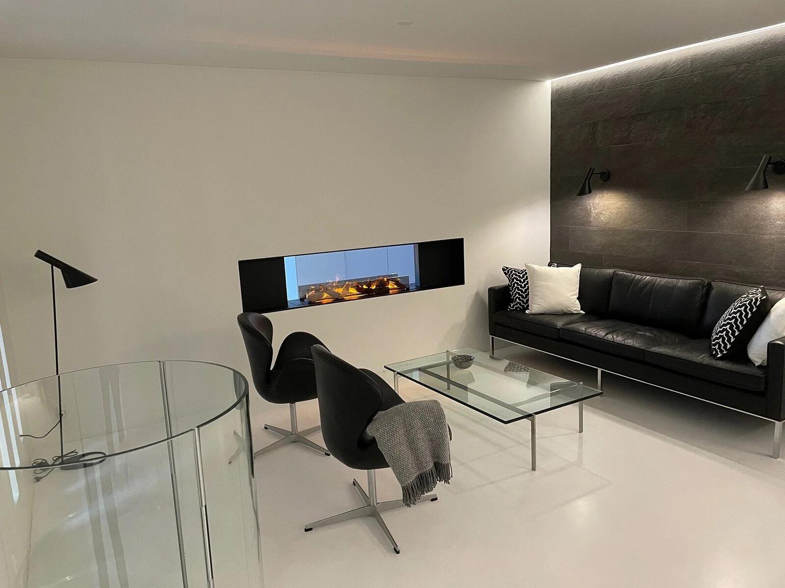 Montreal Panorama Hybrid Mist fire in a dark feature wall with designer chairs
