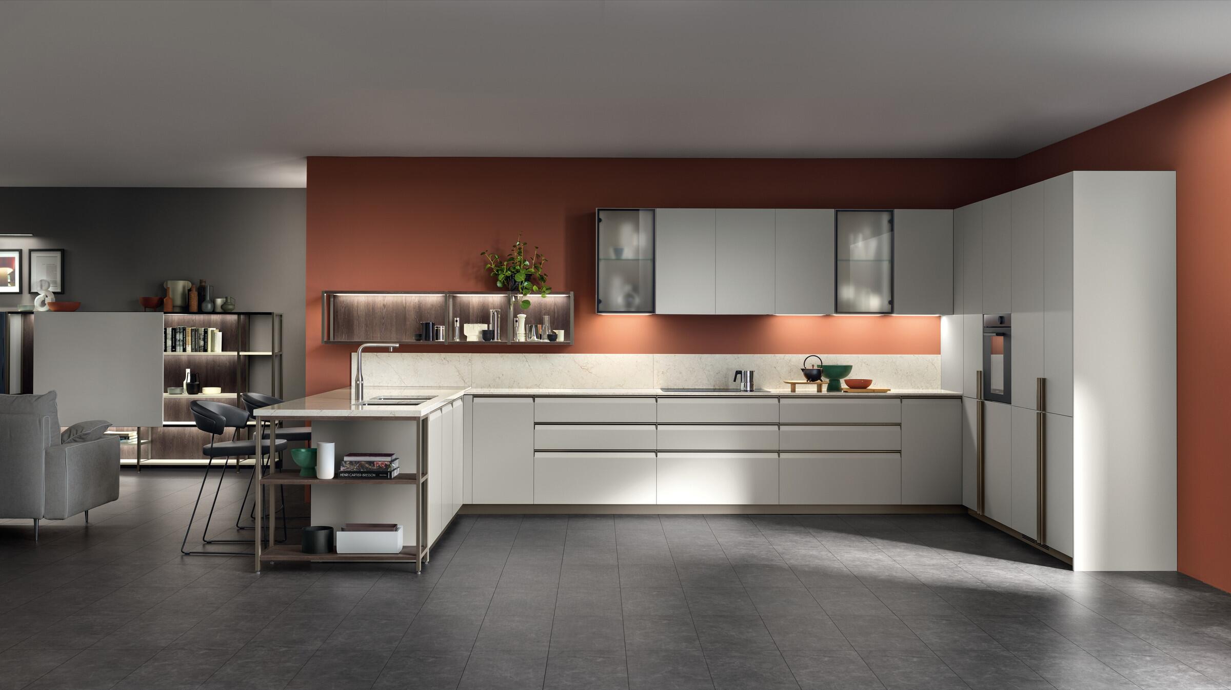 Scavolini Formalia corner kitchen in white with a terracotta feature wall and peninsula