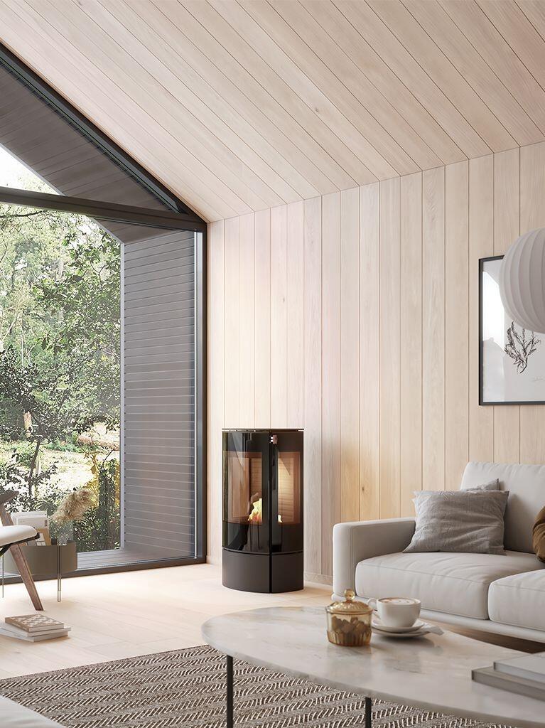 Rais Caro 90 Bio bioethanol stove in black in a timber-clad room with a large window