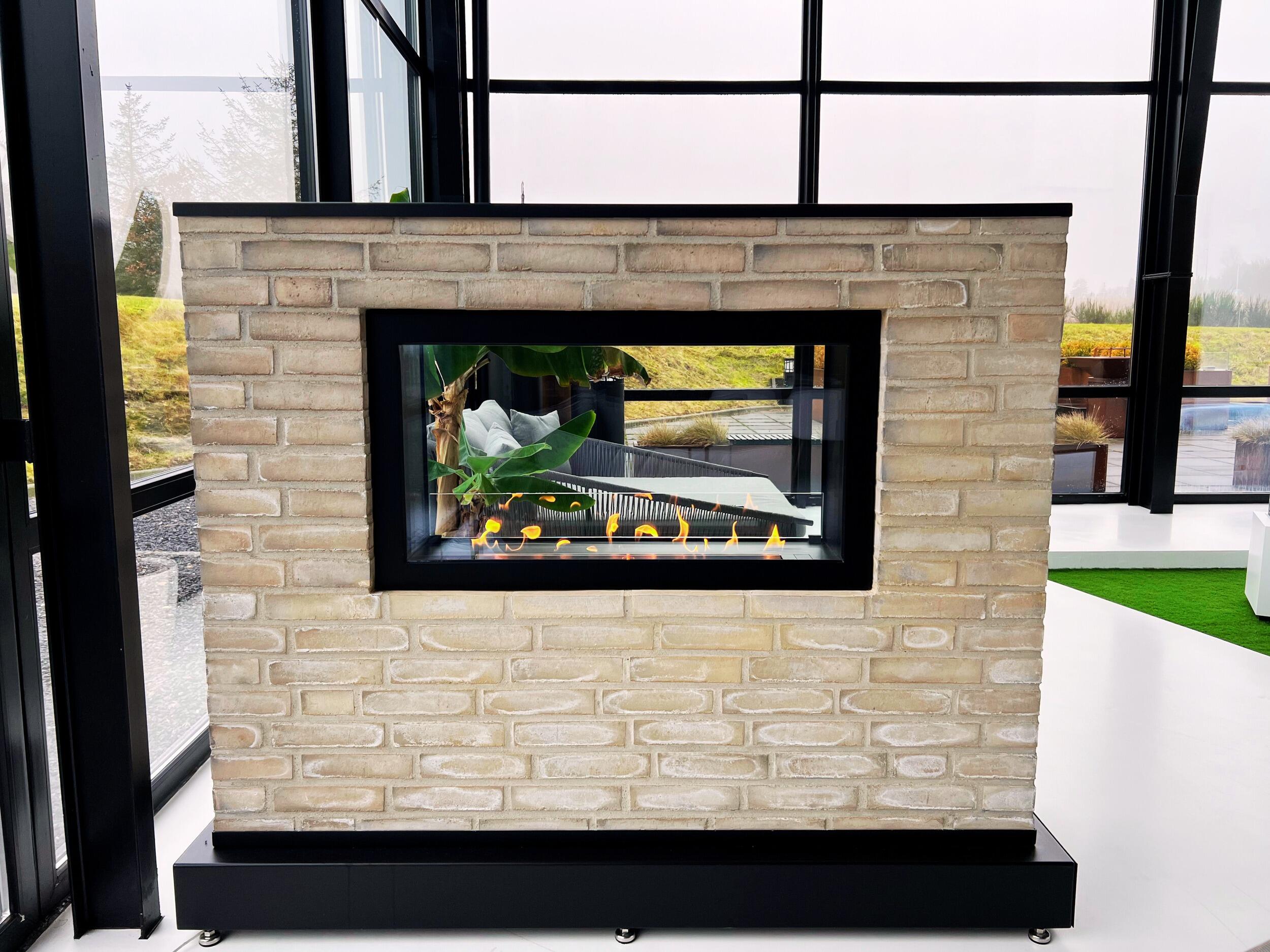 Montreal Clear fire in a freestanding pale brick wall in a glazed room