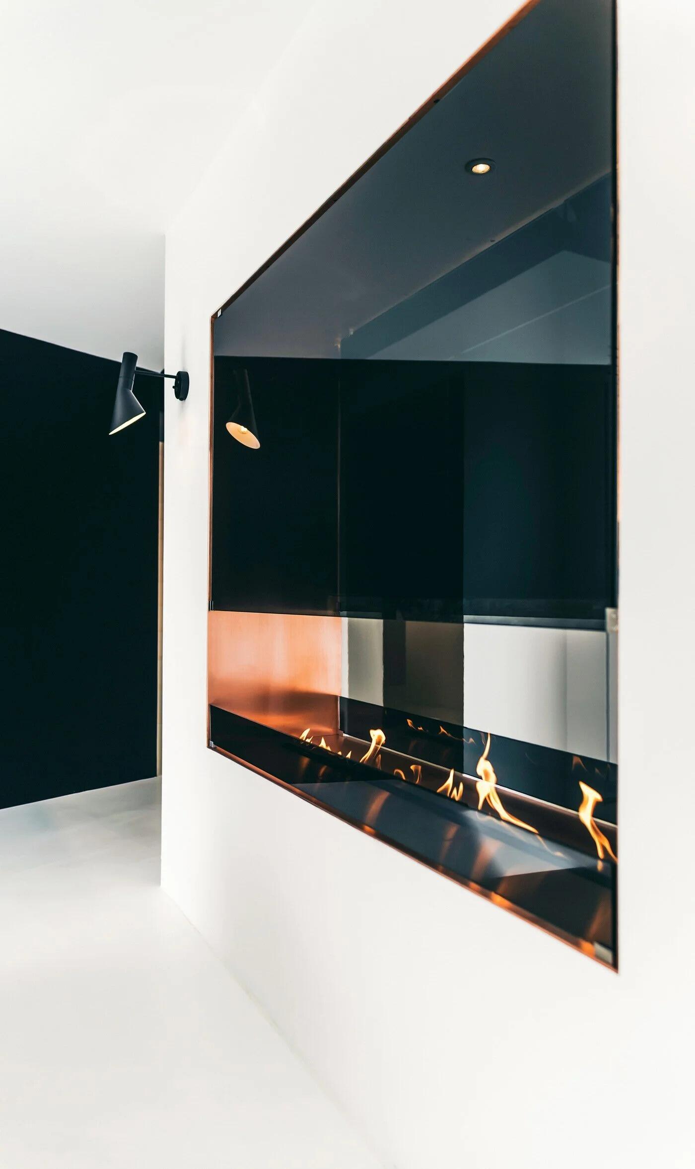 Montreal Vue fire with a tall glass panel built into a white wall