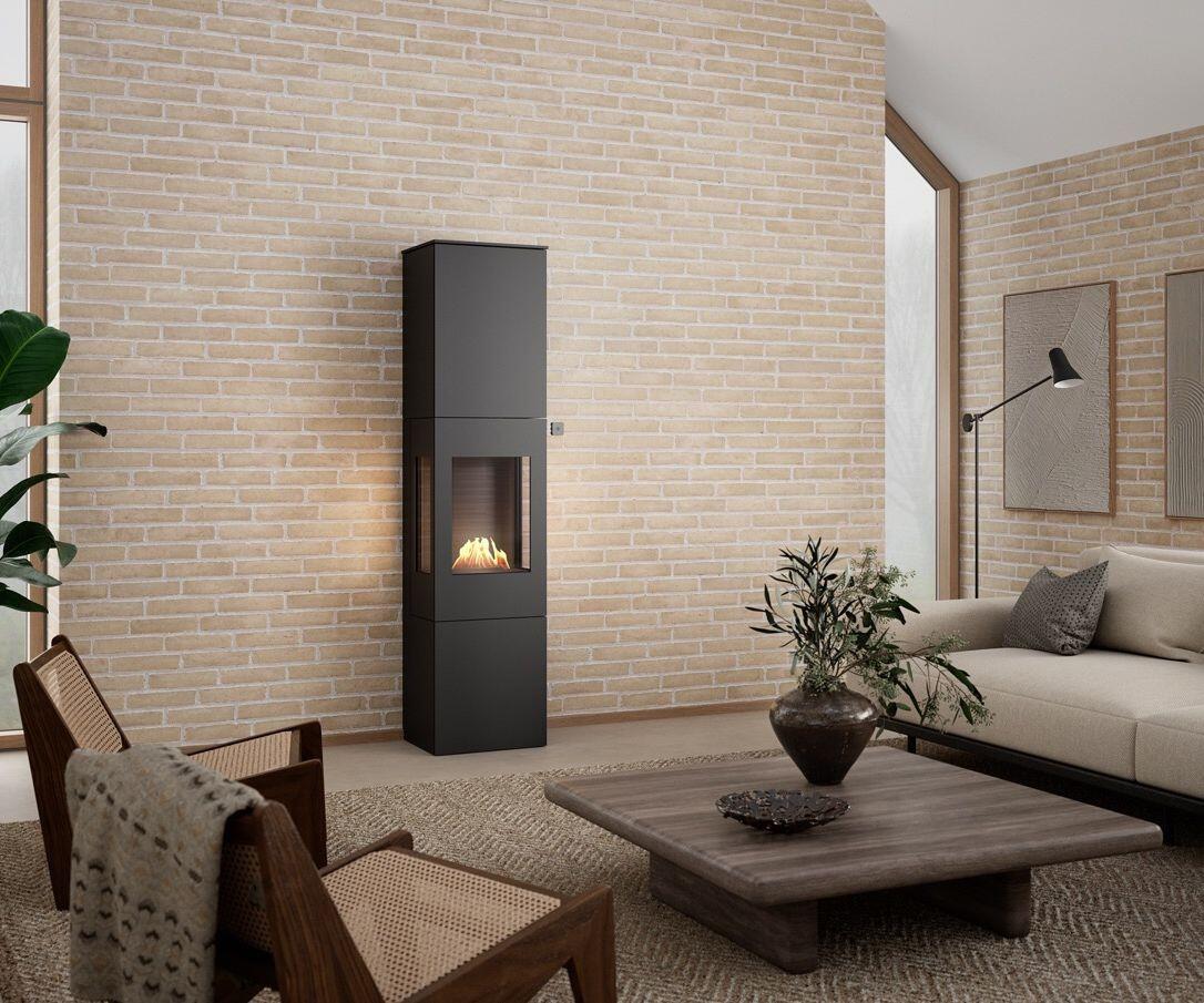 Rais Nexo 185 Bio stove beside a low coffee table and woven armchair